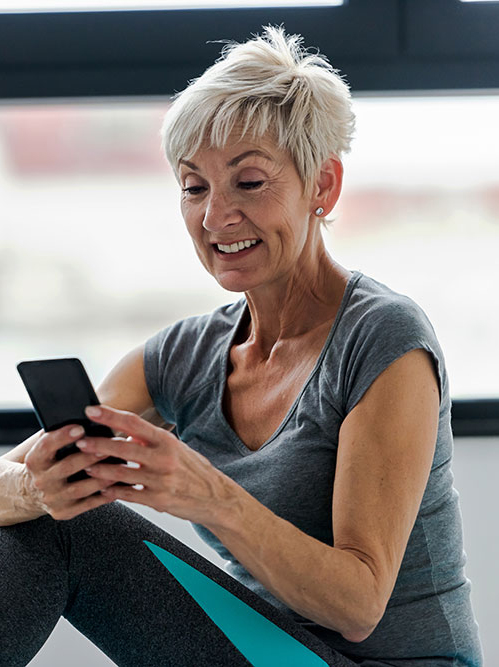 Woman checking her phone after a fitness class